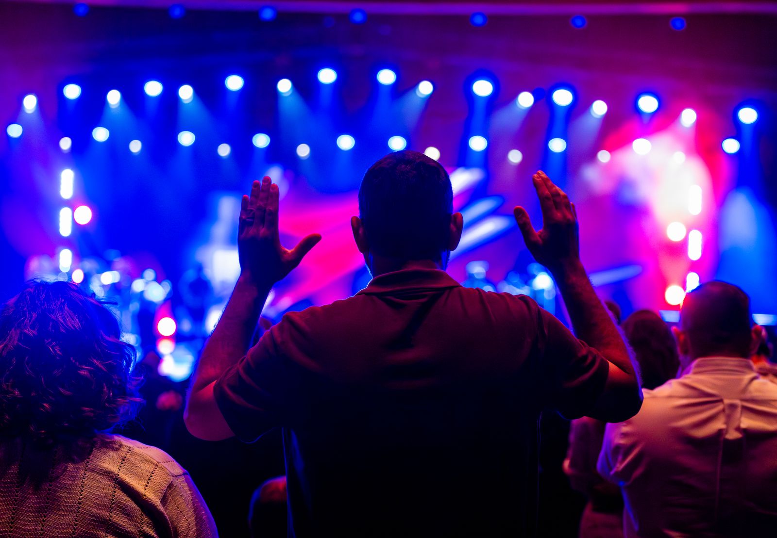 Concert audience under colourful stage lights